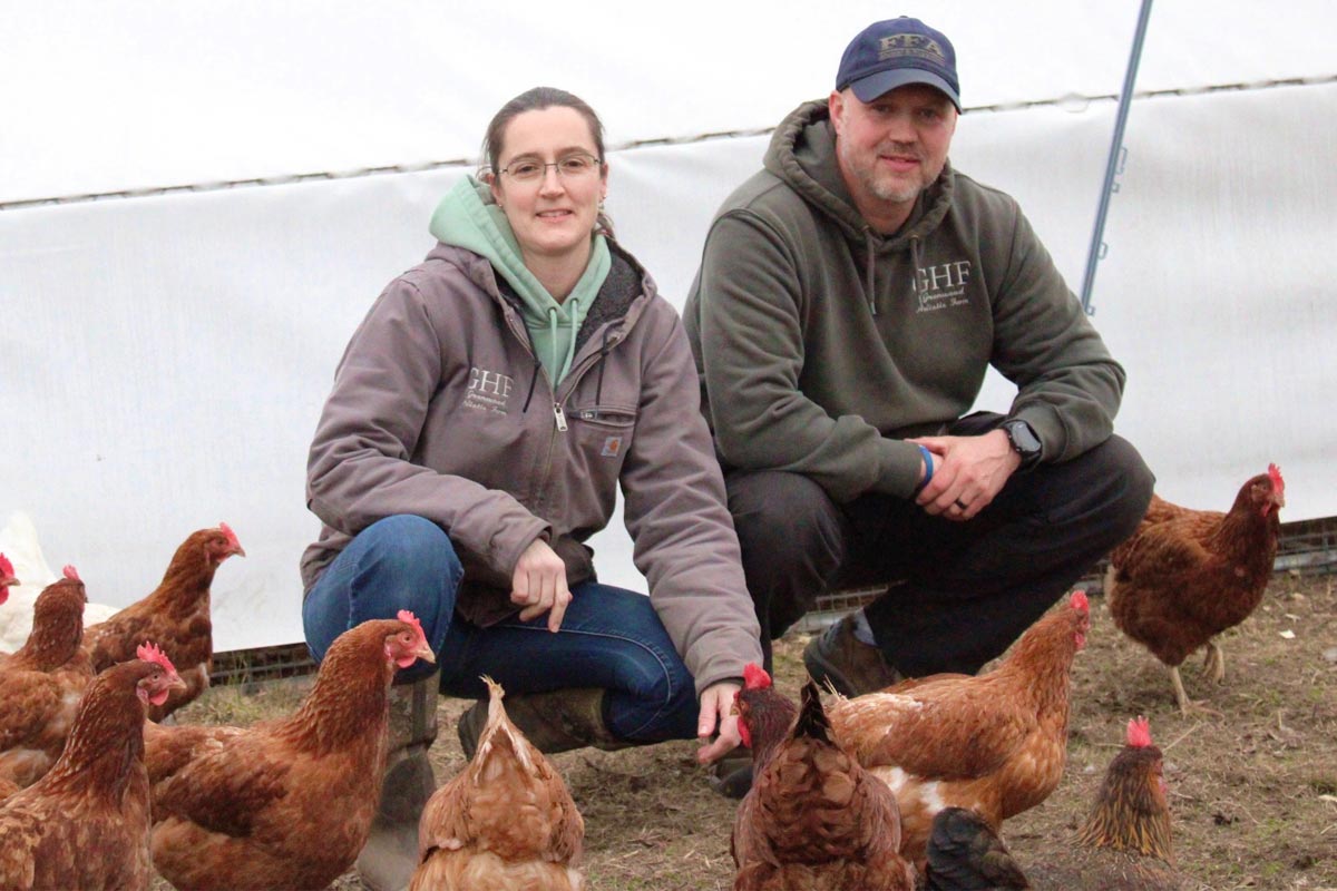 couple with their chickens