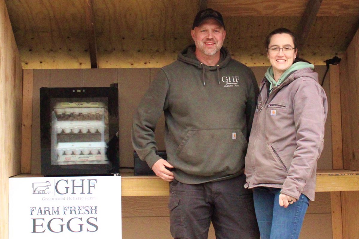 standing inside farm stand selling eggs
