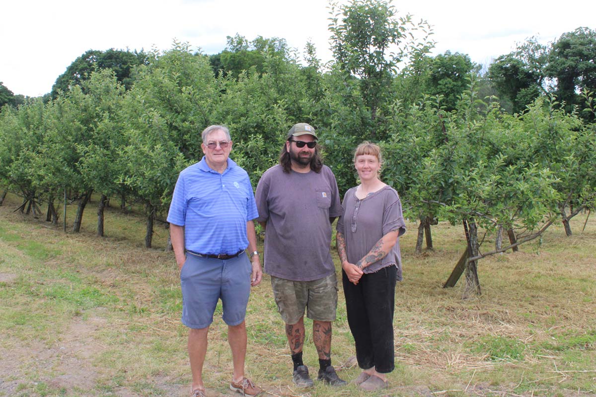 Kaitlyn and Larry with farmer