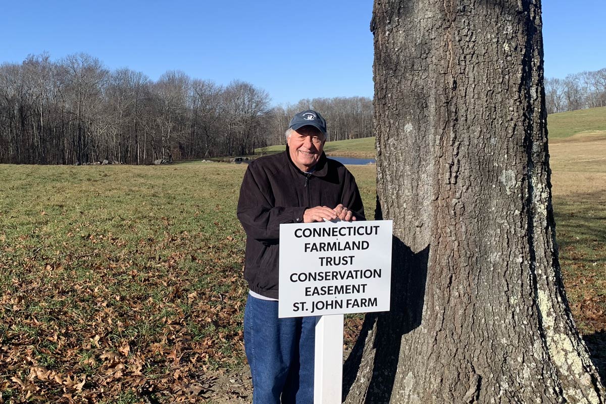 Easement Sign next to tree in field with pond