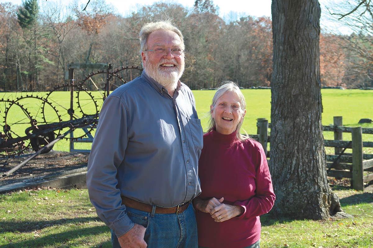 owners standing by field and fence